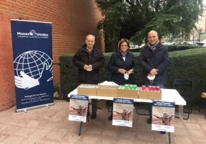 Voluntarios de Manos Unidas vendiendo de velas en la parroquia de San Agustín en  Alcobendas