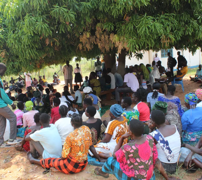 mr. gwokotho cephas local council 3 chairperson in stripped shirt talking to group before input distribution
