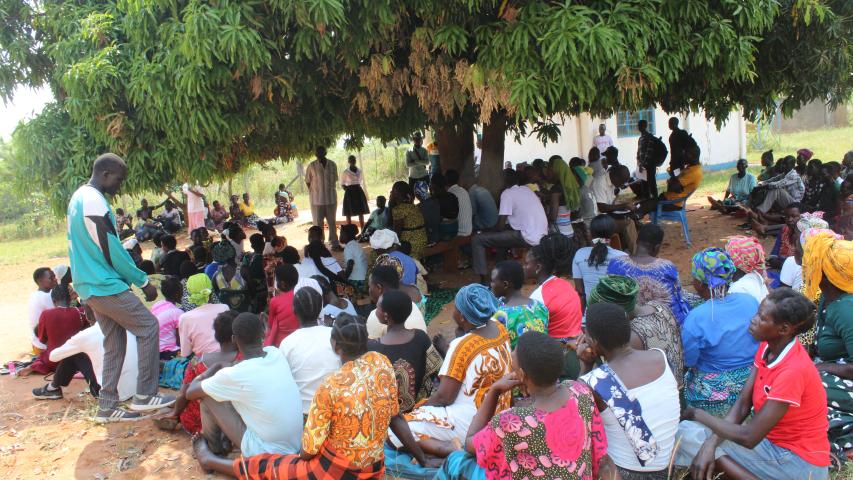 mr. gwokotho cephas local council 3 chairperson in stripped shirt talking to group before input distribution