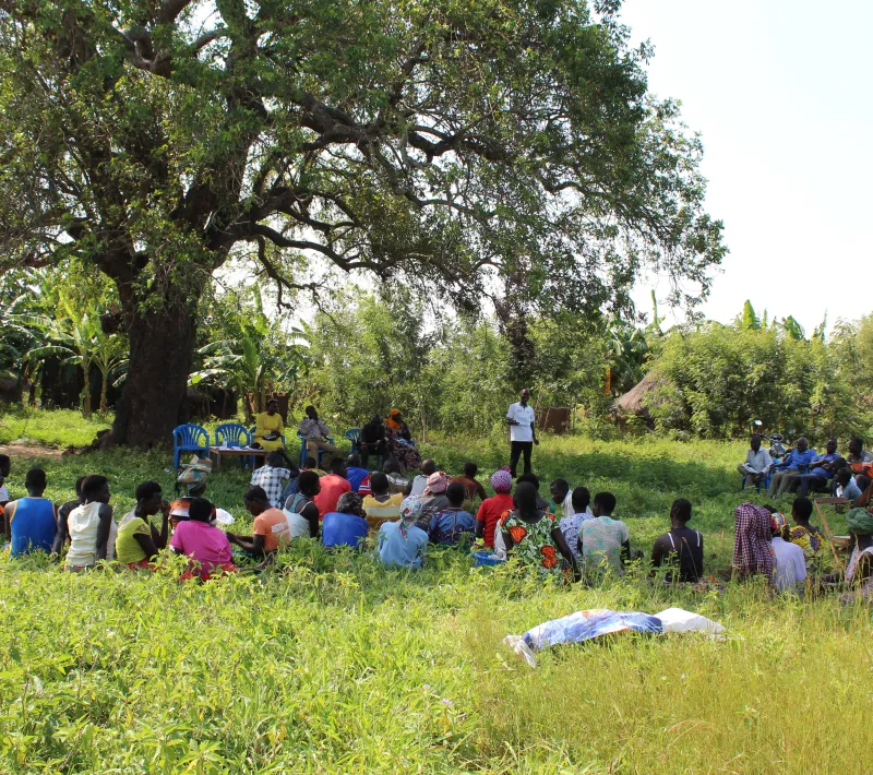 project officer in white tshirt during group formation in kabaka village