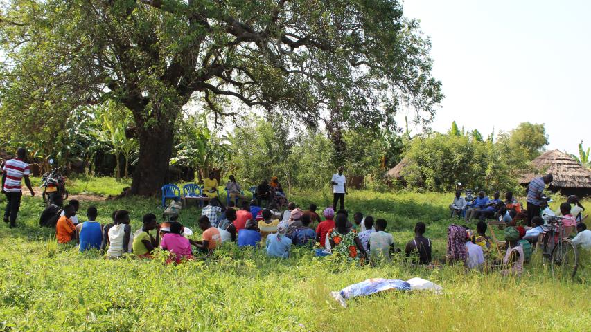 project officer in white tshirt during group formation in kabaka village